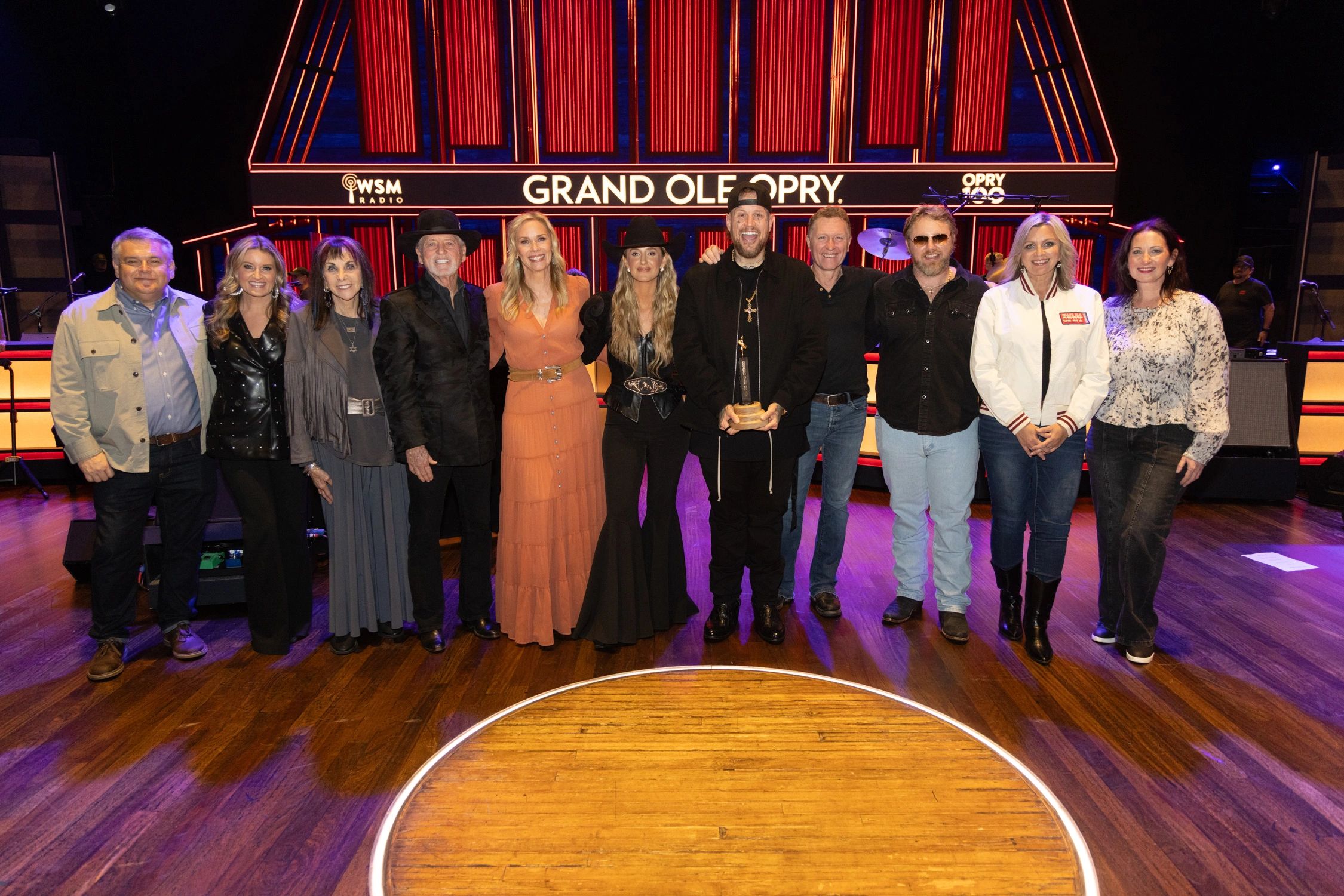 From left to right: Opry's Dan Rogers, Opry host Kelly Sutton, Lily Isaacs, Larry Gatlin, Leanne Morgan, Lainey Wilson, Jelly Roll, Craig Morgan, ERNEST, Sonya Isaacs and Opry's Jenn Tressler. Photos credit: © Grand Ole Opry, photos by Chris Hollo